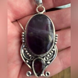 Elegant amethyst and sterling silver pendant with 22 inch silver plated chain.